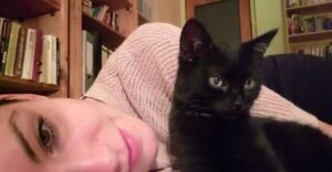 Women with black cat is depicted